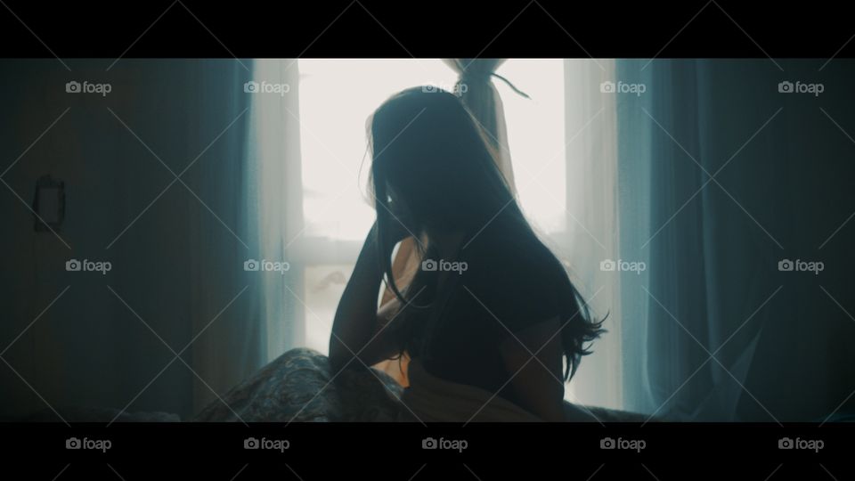 Girl looking out window from bed.

From a short film I directed 
https://youtu.be/BDa3cAE62zQ