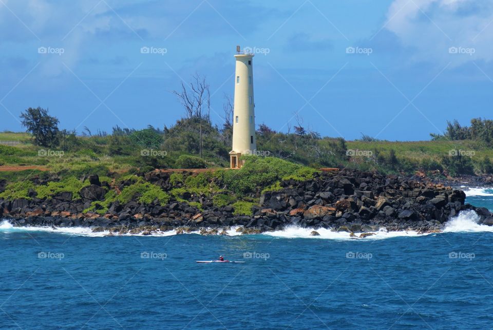 Lighthouse sits on a rocky outcropping on the island of Kauai in the Hawaiian islands