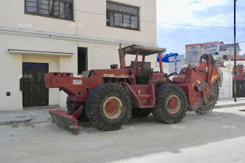 An old red traktor on the street