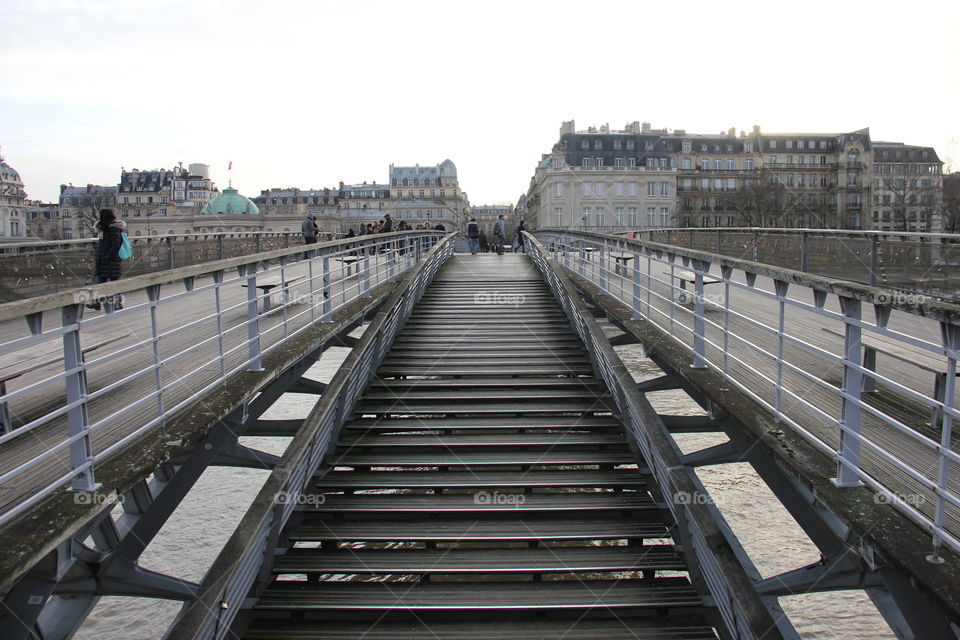 Walking bridge in Paris. Symmetrical bridge. Perspective. Cityscape. Two-level bridge