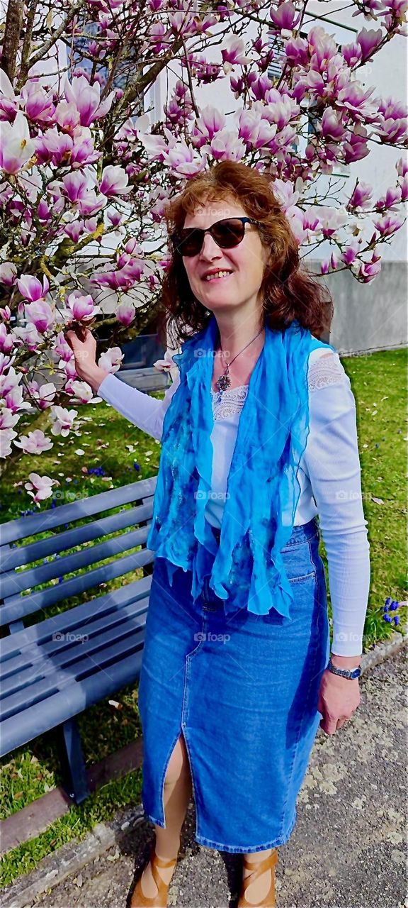 This young lady is standing outside the church in “Falkenstein”, a small town in the “Bayerischer Wald”, the “Bavarian Forest” appreciating the tree in full bloom. 2024. Hypnotic Productions