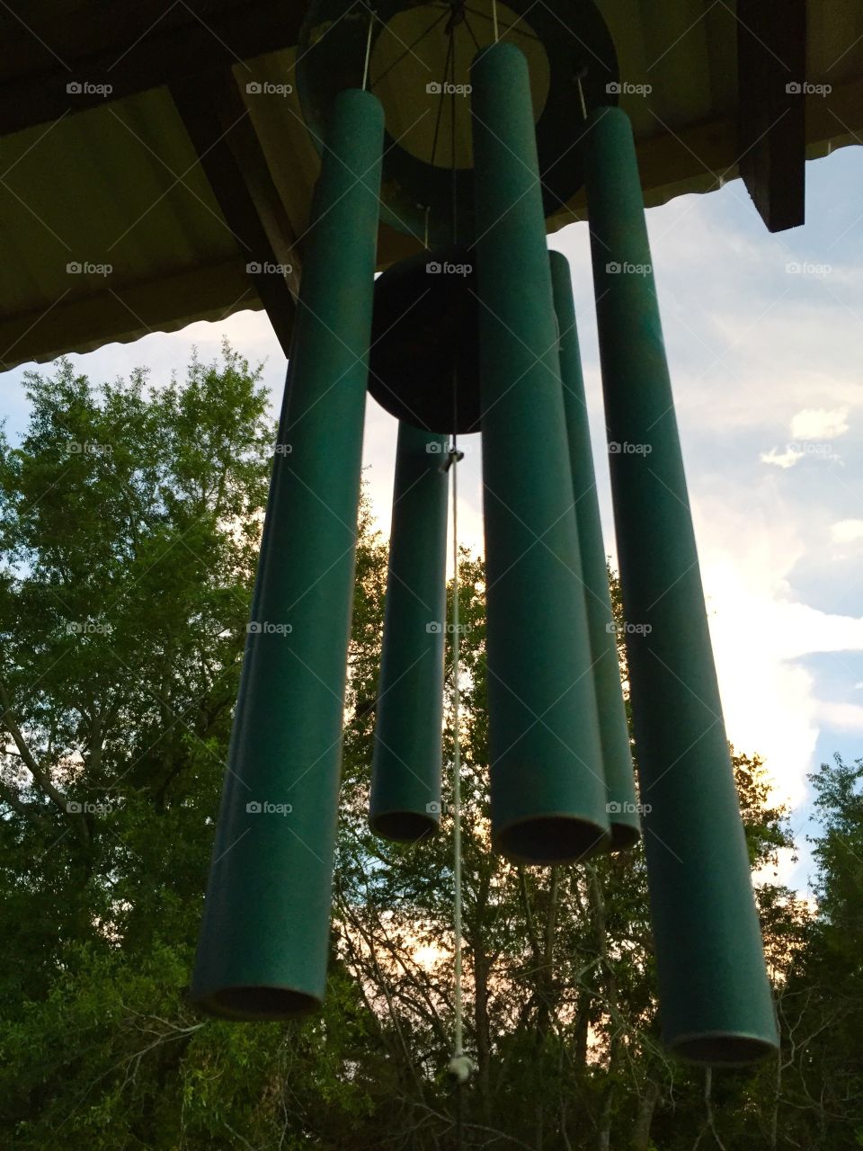 Green colored pipe chimes salvaged and restored from tornado we had.