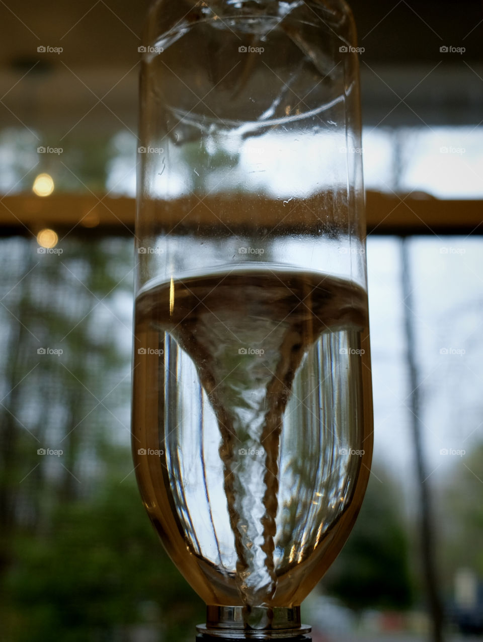 Vortex in a bottle of water simulating a tornado from a children’s weather experiment kit 