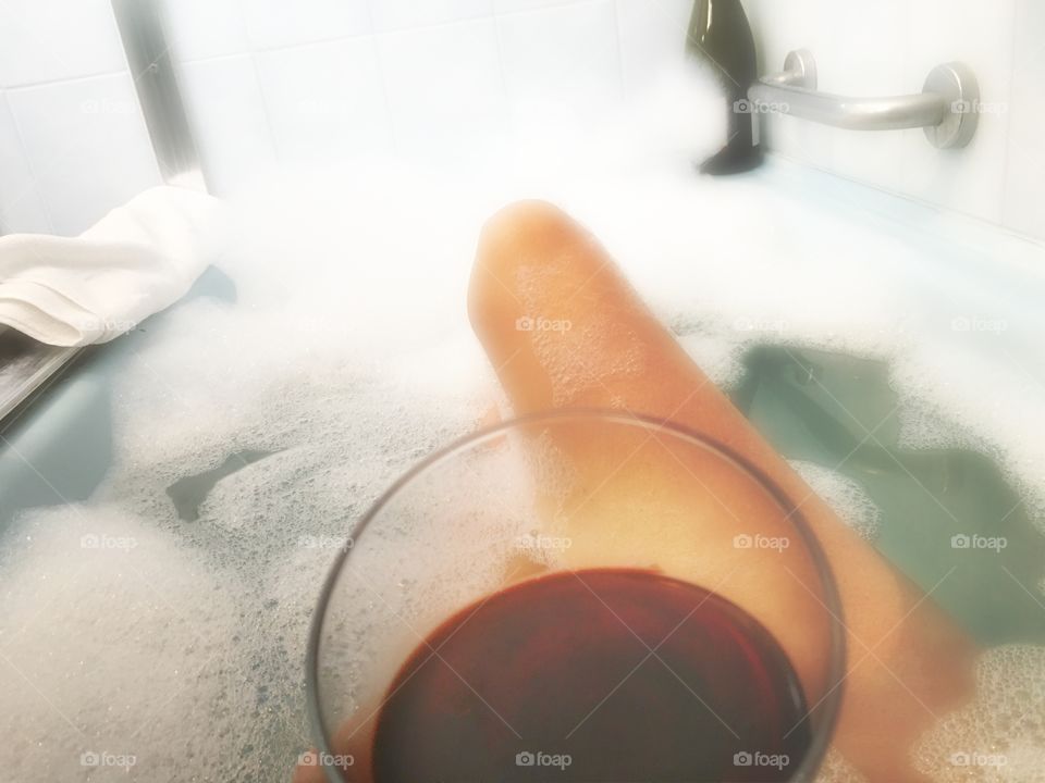 Point of view while unwinding in a hot bubbly bath with a great glass of wine 