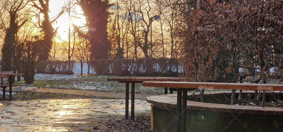 Beautiful view of sunlight that gently lights the park reflecting on the stone path