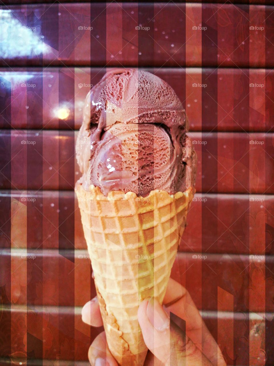 Ice cream cone.. Chocolate ice cream cone on the red wall. It's delicious at Pai walking street Maehongson Thailand.