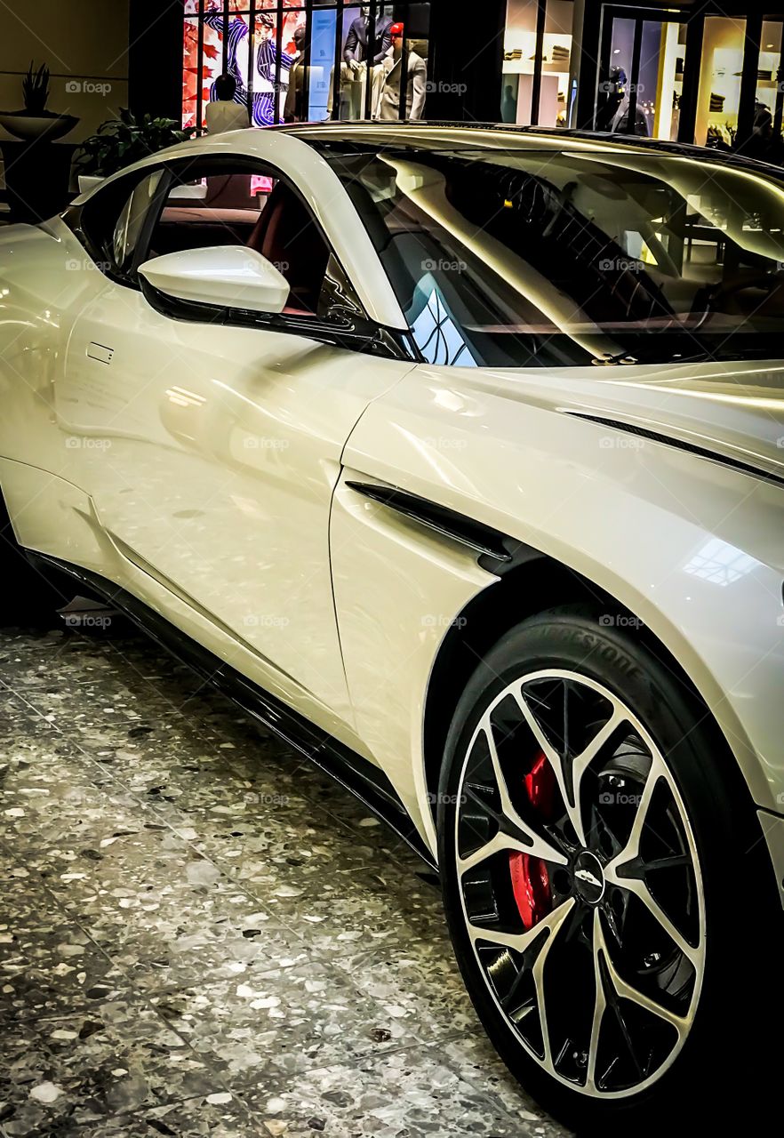 Shopping in an Aston Martin car