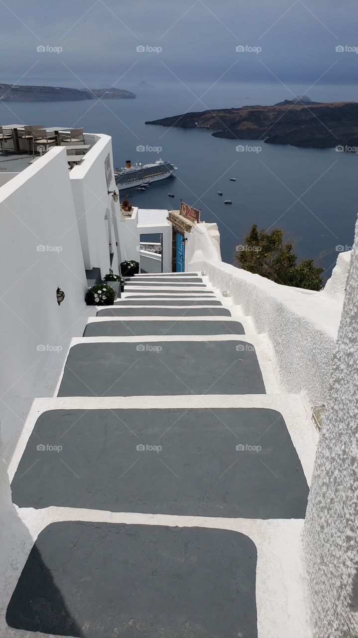 View from above, staircase down to ocean, in Santorini, Greece.