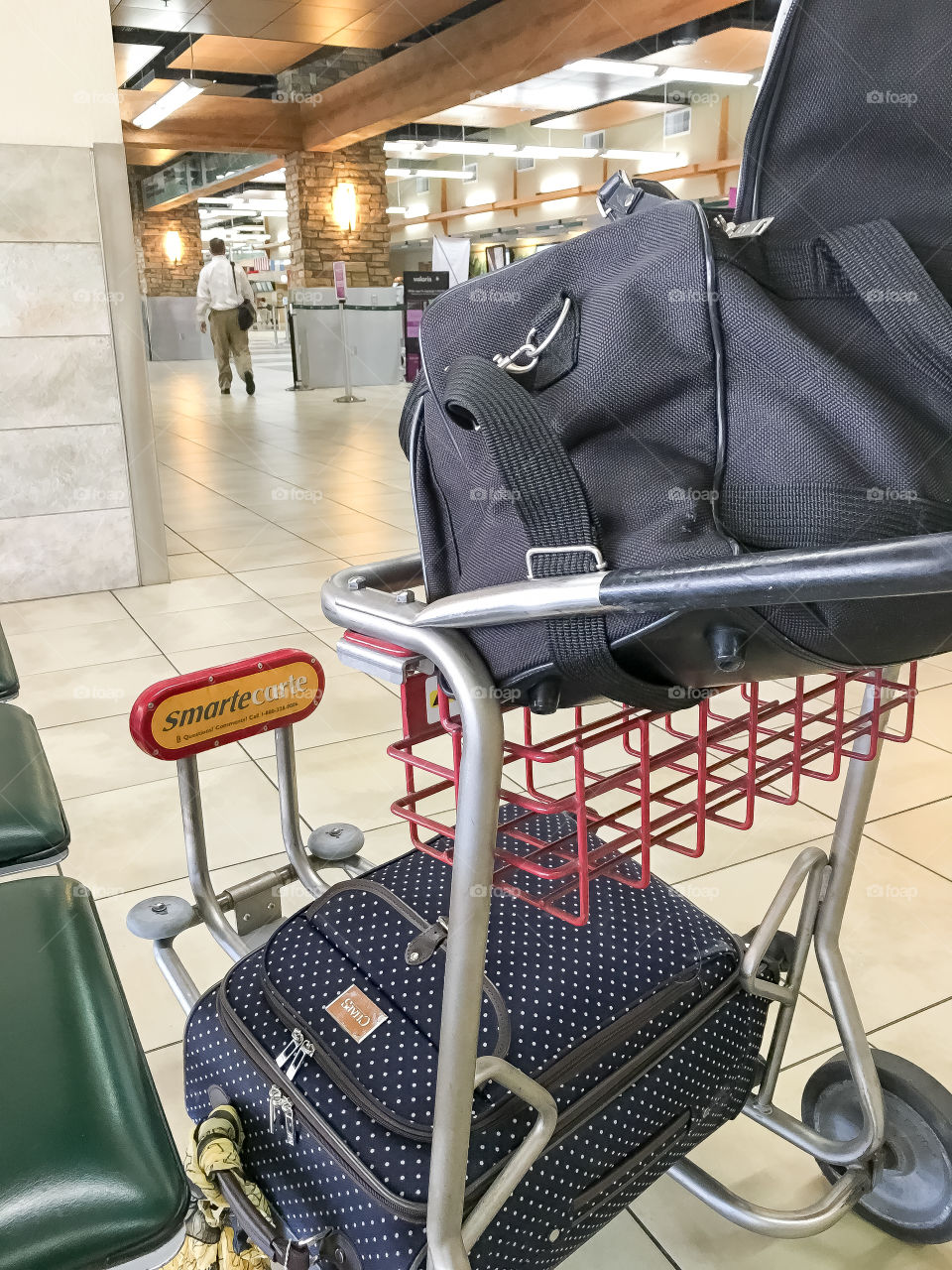 Luggage on luggage cart inside airport