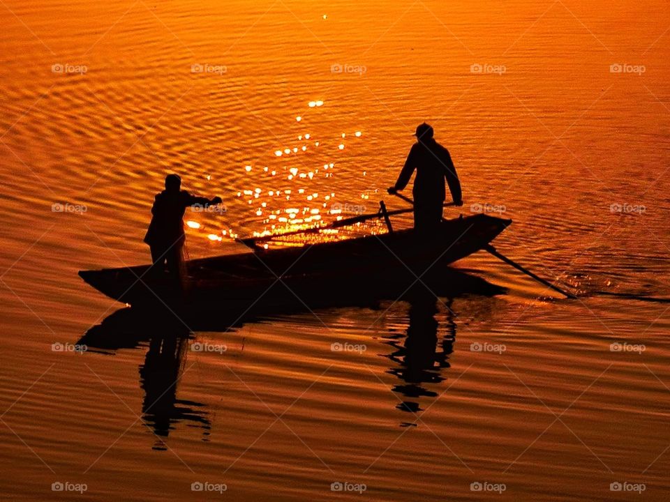 The hardworking fishermen in the sunset