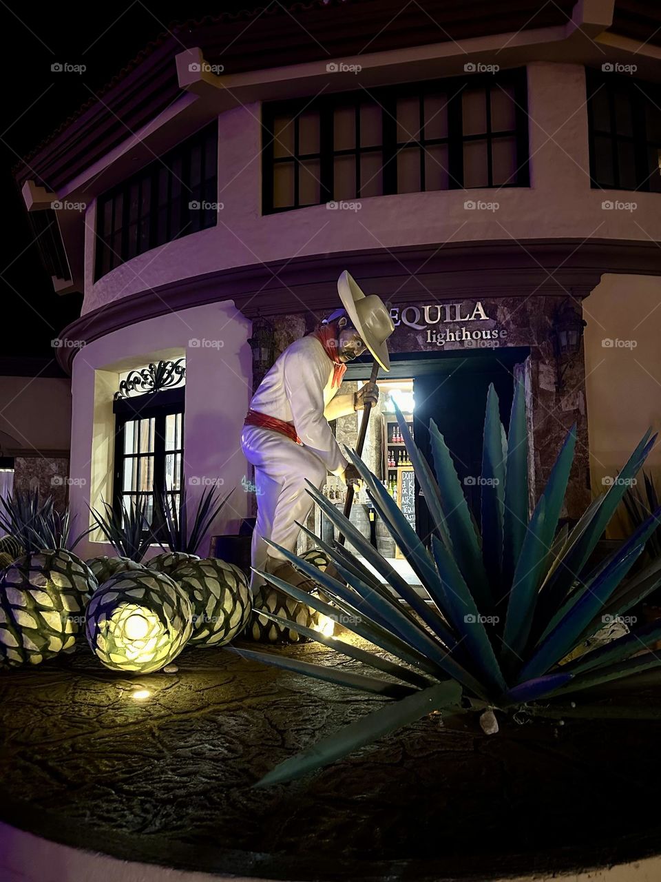 Rustic building and windows during the night, while a curious figure appearing in front of the luminous.