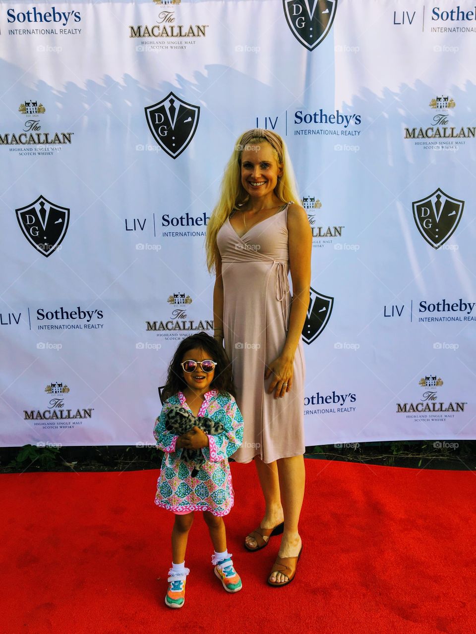 Walking down the scarlet red carpet 
pausing 
and posing
for photos
with beautiful young child