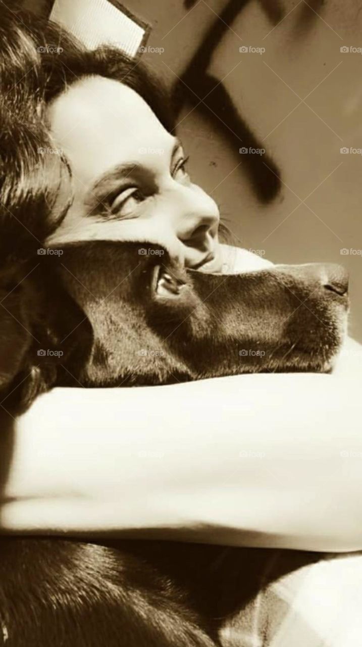 In a hug and through the looks we perceive the love between a dog and its caretaker.