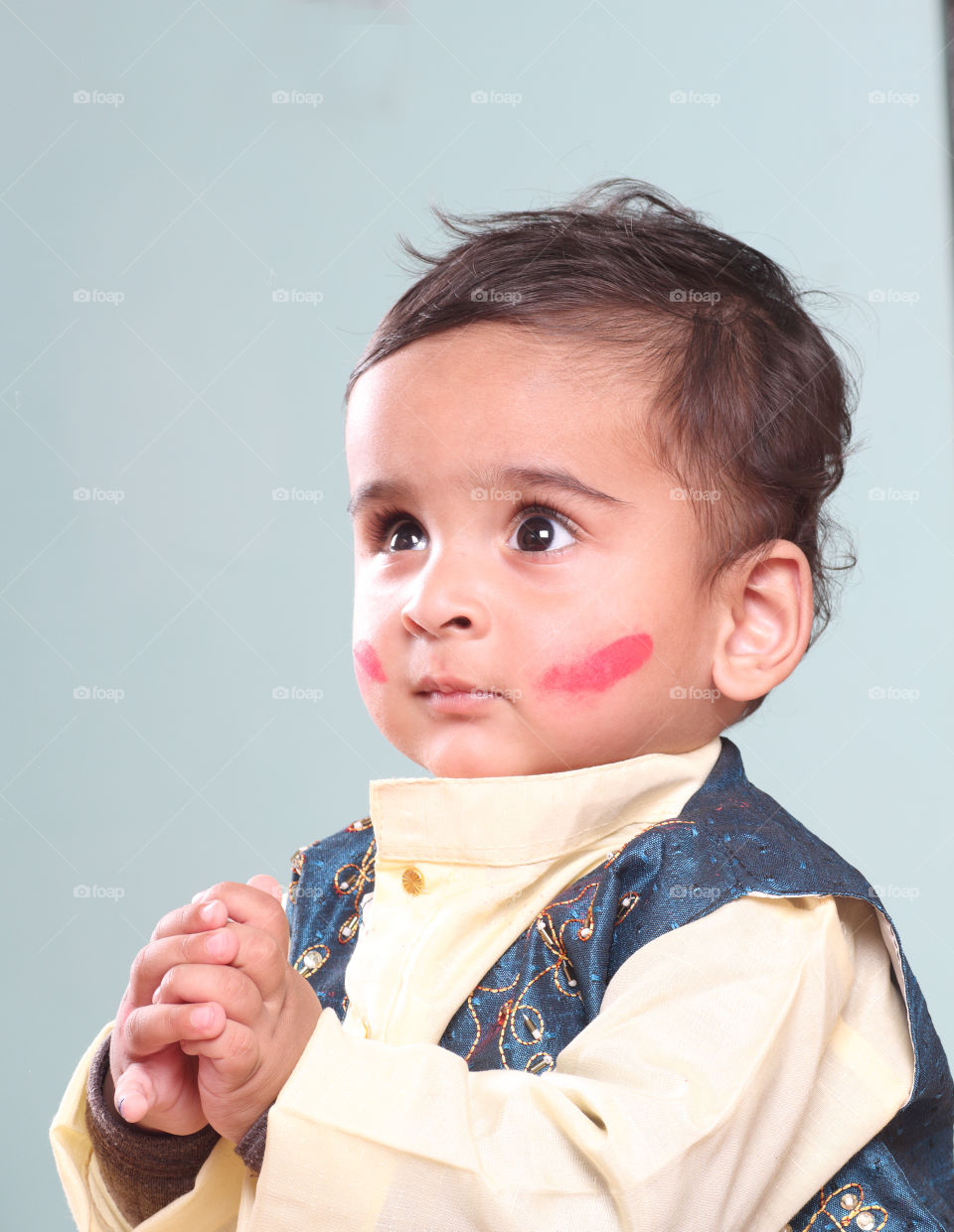 Cute little baby boy with color on his face, playing holi