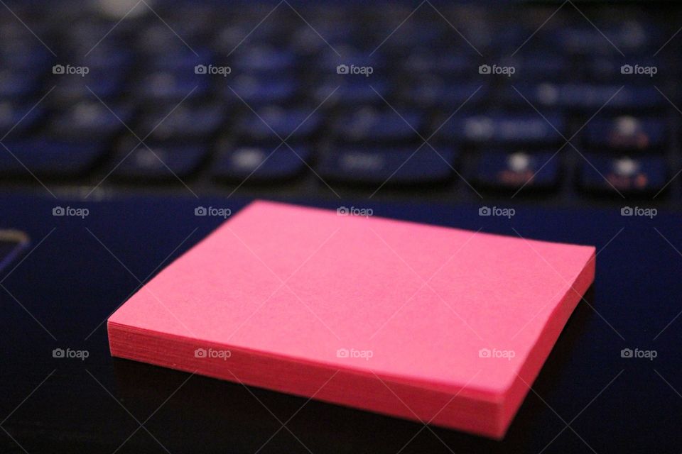 Pink notepad on laptop