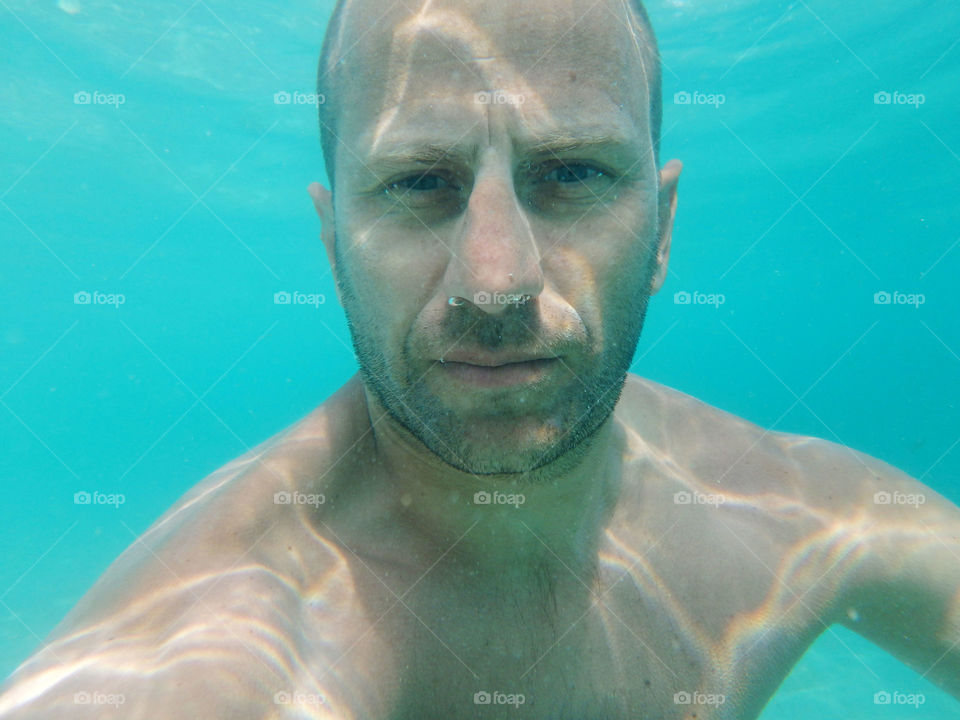 closeup underwater portrait. closeup male underwater portrait