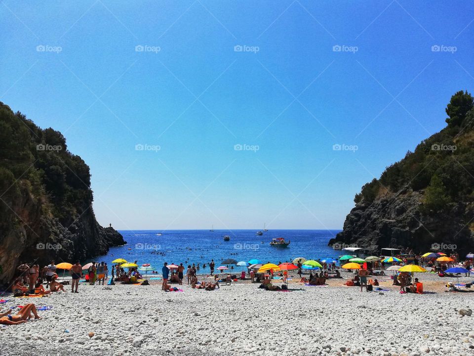 bathers and colorful beach umbrellas on the beach