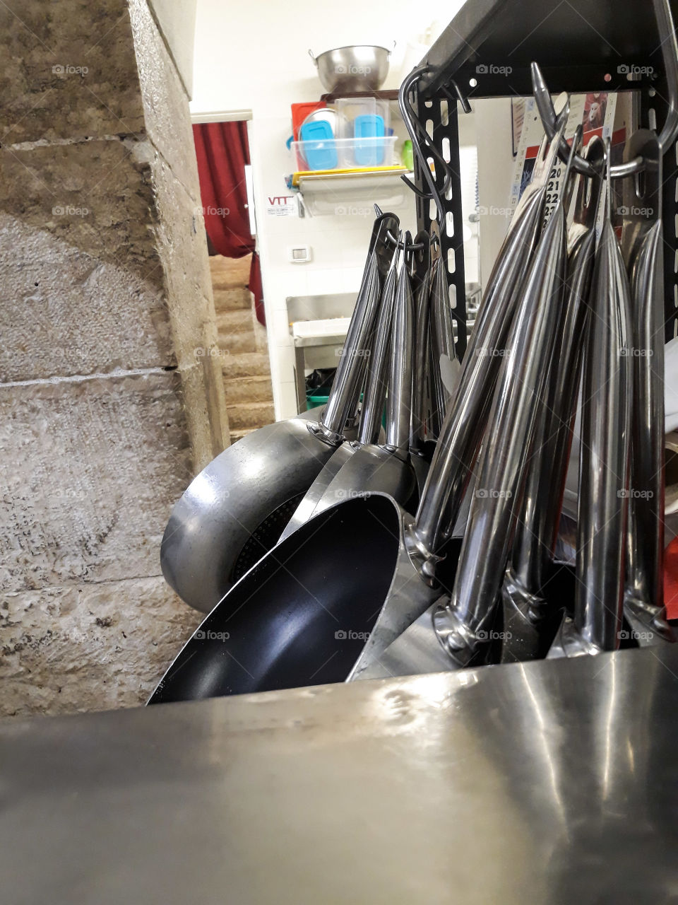 Metal cooking pans in a professional kitchen of an Italian restaurant. Clean an professional instrument and location