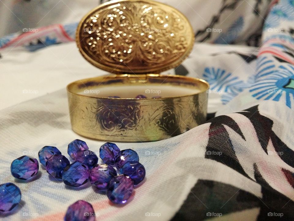 Purple gems beside a golden container