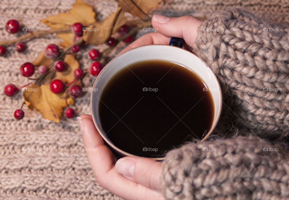 Women's hands holding coffee cup