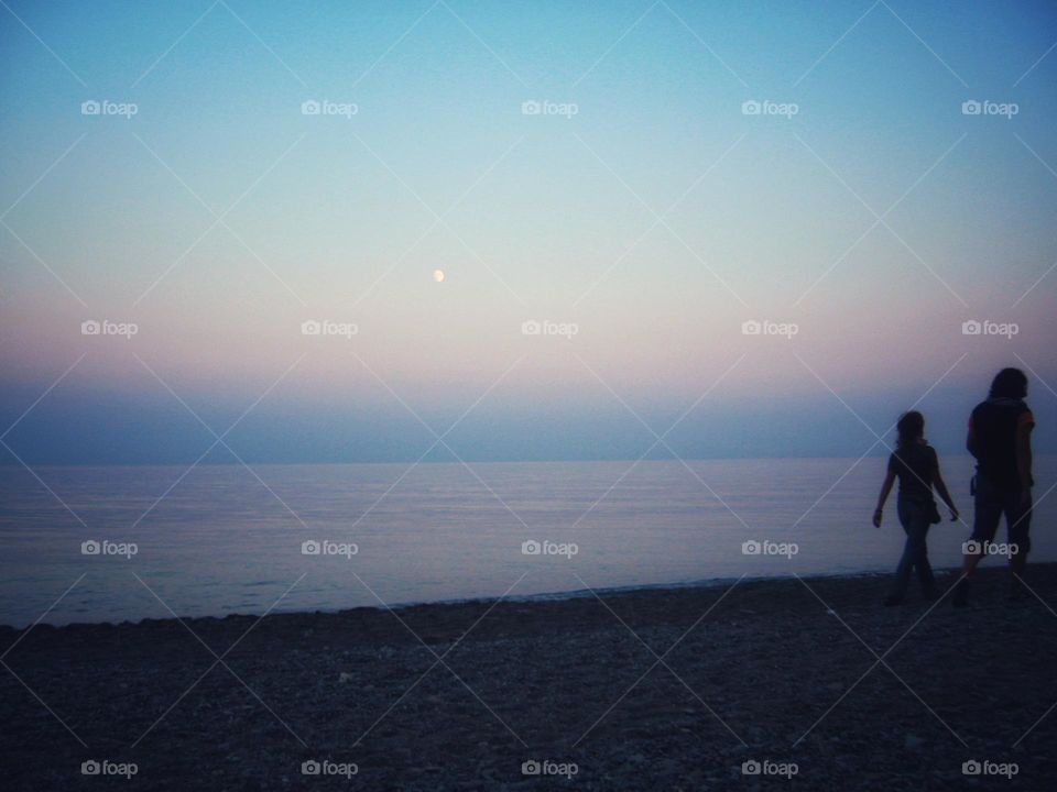 A walking couple in a beautiful evening.
