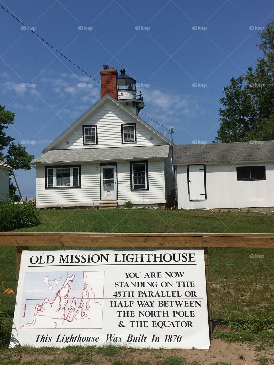 A lighthouse protects the southern latitudes from the dark of the north on Michigan’s 45th Parallel