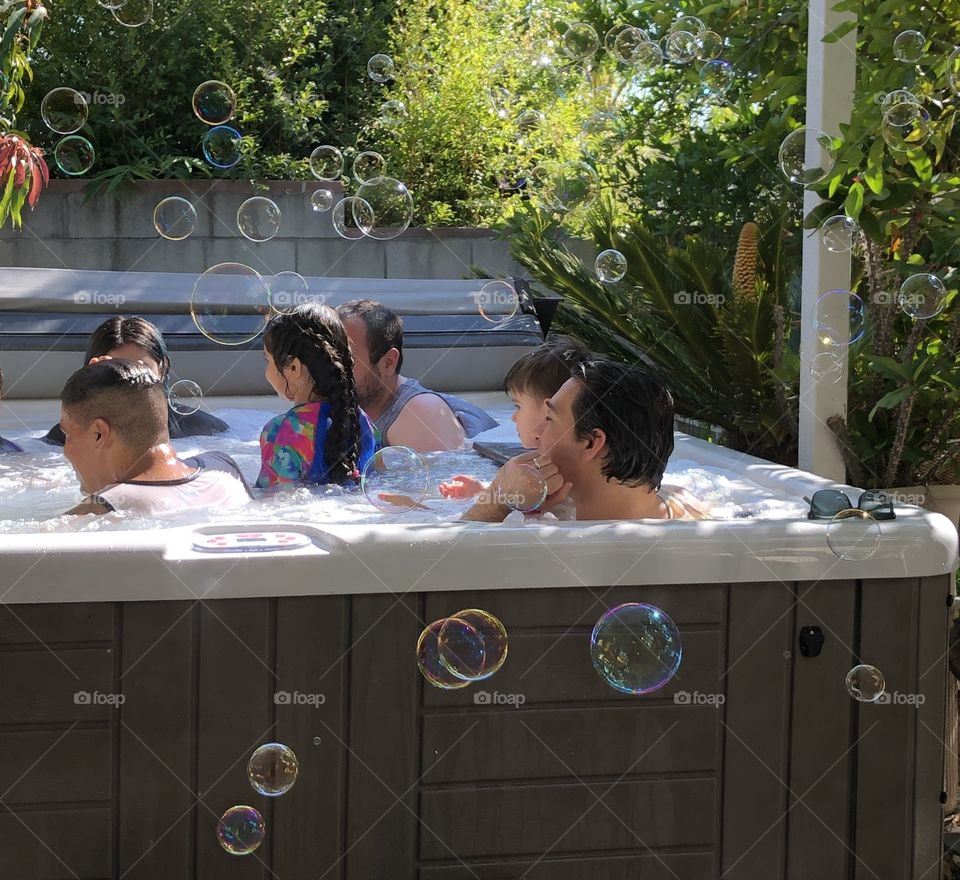 Family Relaxing in jacuzzi with bubbles