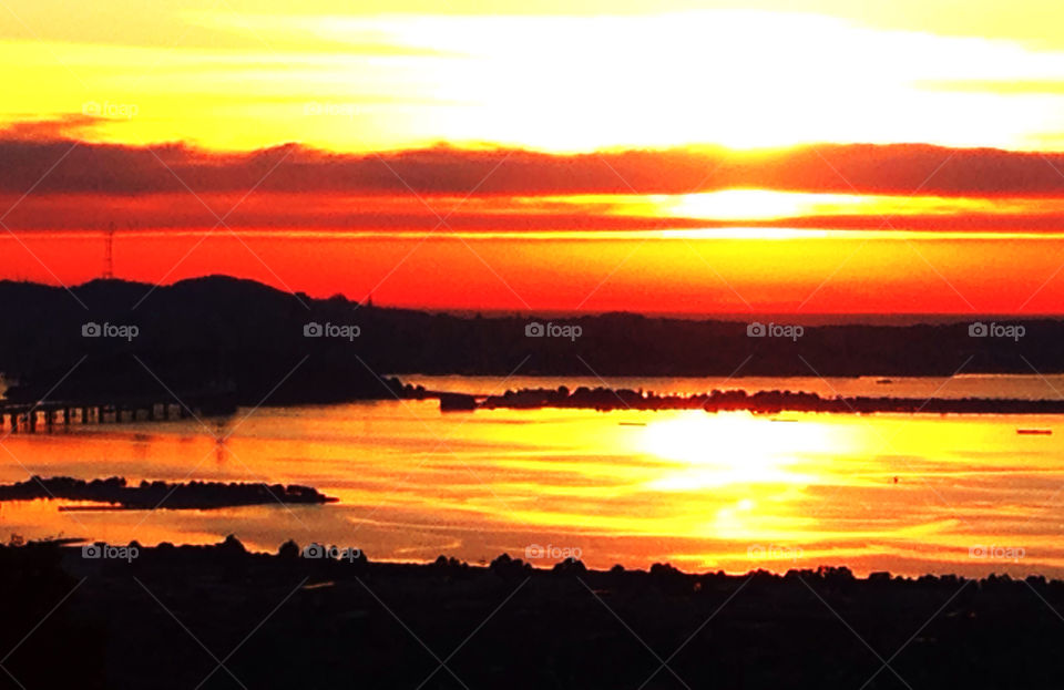 Explosive red and yellow sunset over San Francisco Bay with full view