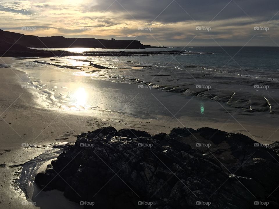 Beautiful remote beach with reflections on water