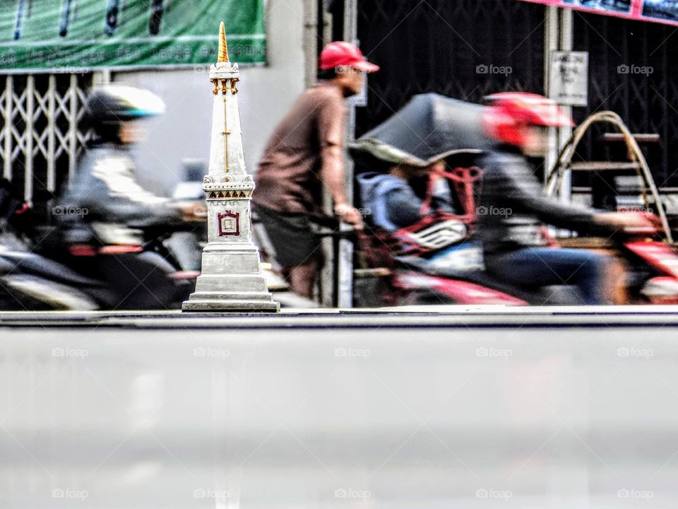 The monument of the city of Yogyakarta in the country of Indonesia among the crowds of the city.