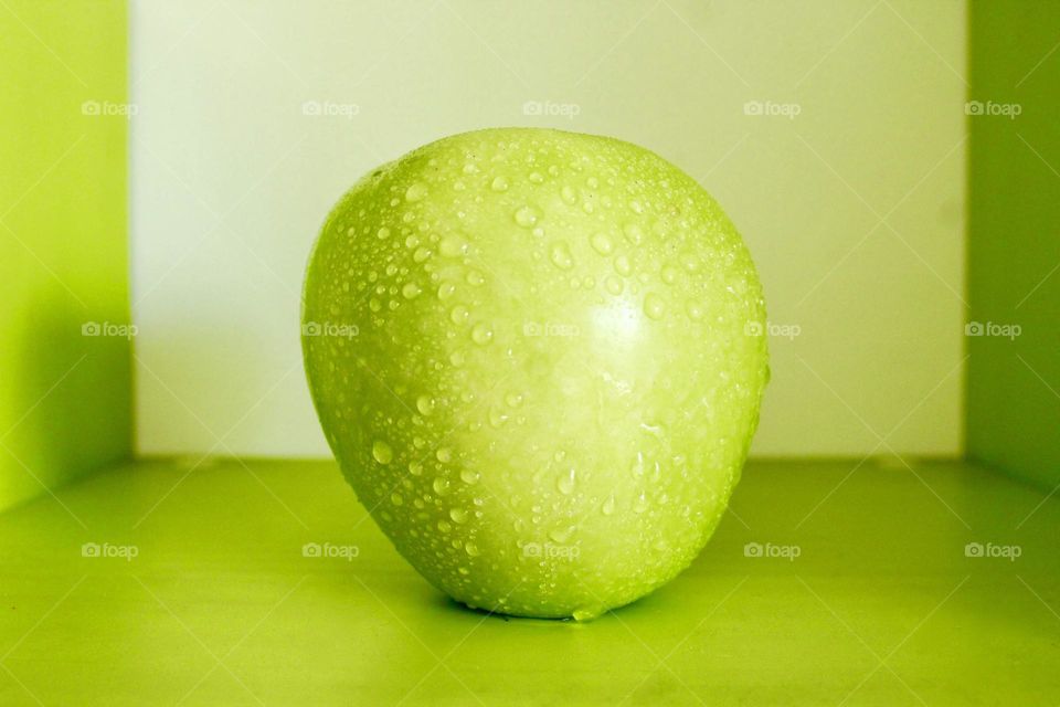 Green Apple on green background 