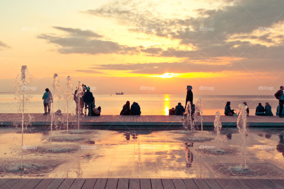 People At The Dock Enjoying The Sunset
