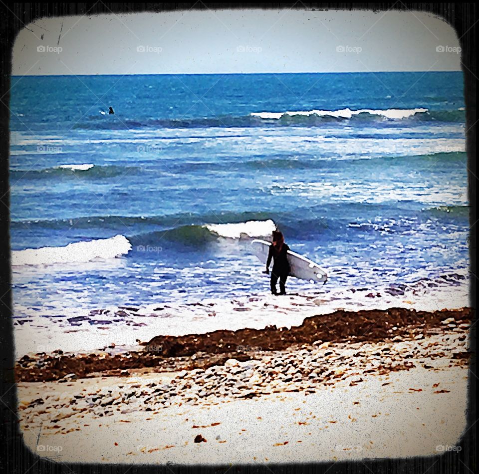 Girl surfing at beach.