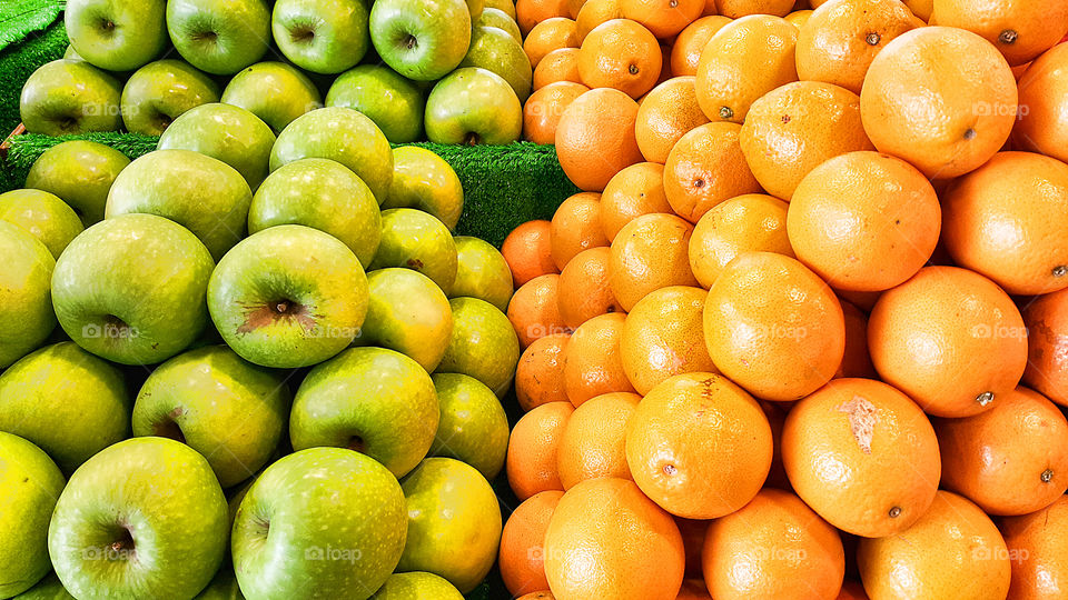 Heap of an apple and oranges