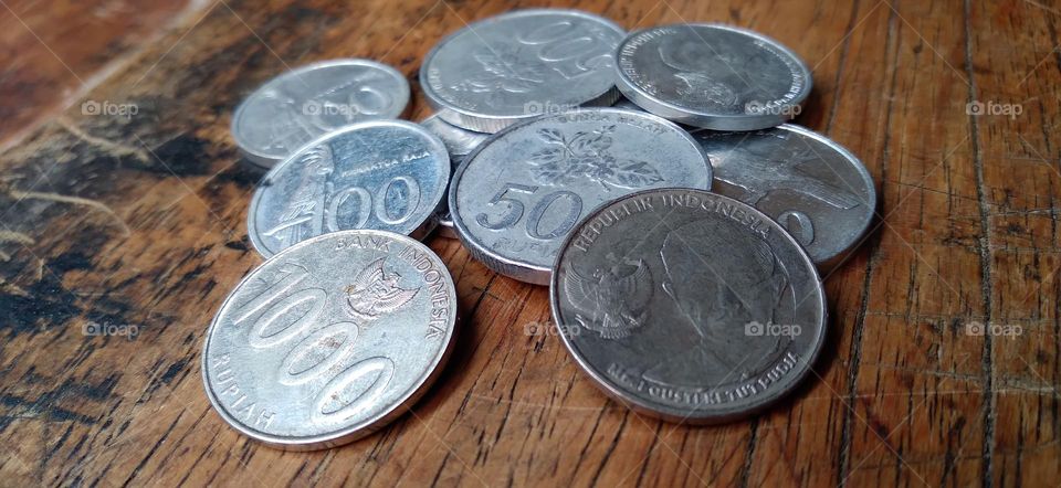 Rupiah coins on an ancient wooden table