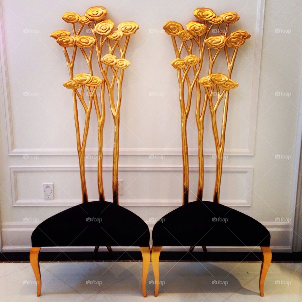 two tall chairs in gold and velvet