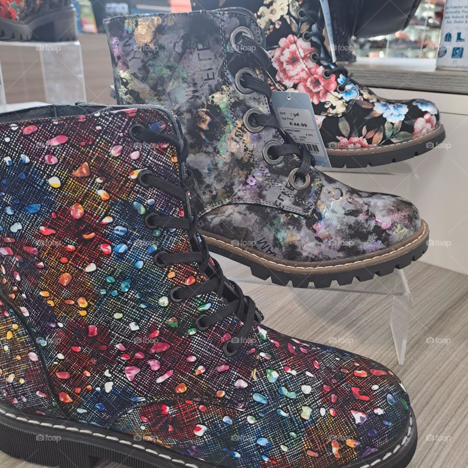 3 new colourful boots on shelf display in a shop floral