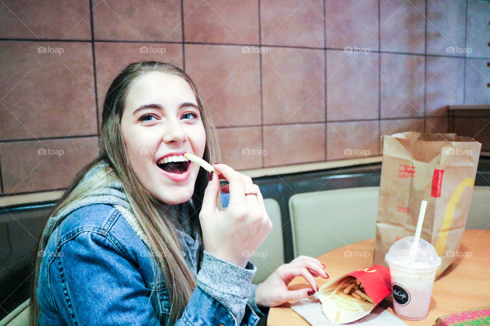 McDonald’s- girl eating at McDonald’s.