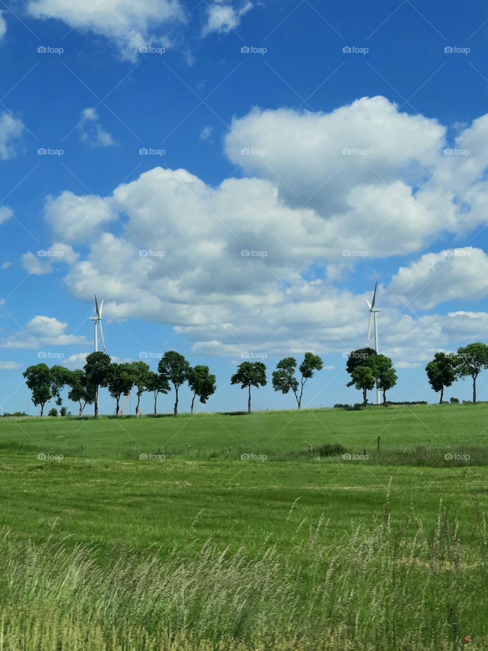 pair of windmills on horizon