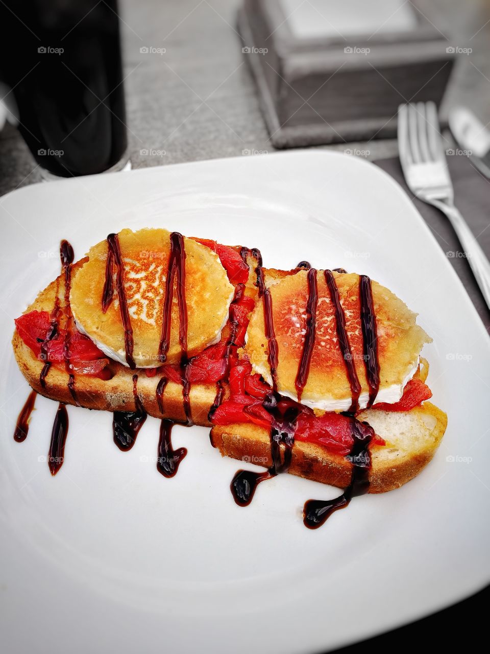 goats cheese on sun-dried tomatoes and toast drizzled with sweet BBQ sauce