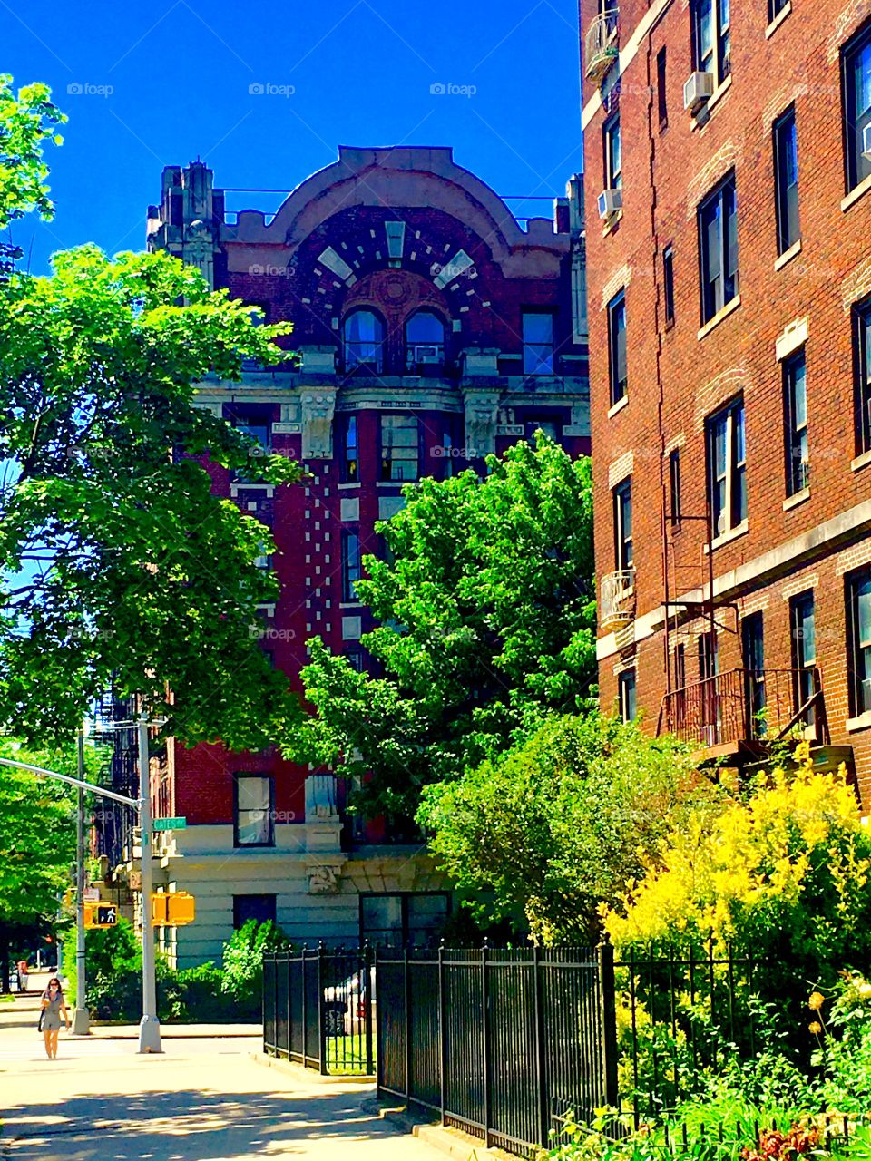 Fort Greene, Bklyn has old style brownstones w elements from a bygone age: arched roofs and windows arranged in demi circles, stucco ornaments contrasting the red bricks, towers, columns in offset entrances w steps etc. 2020 Hypnotic Productions