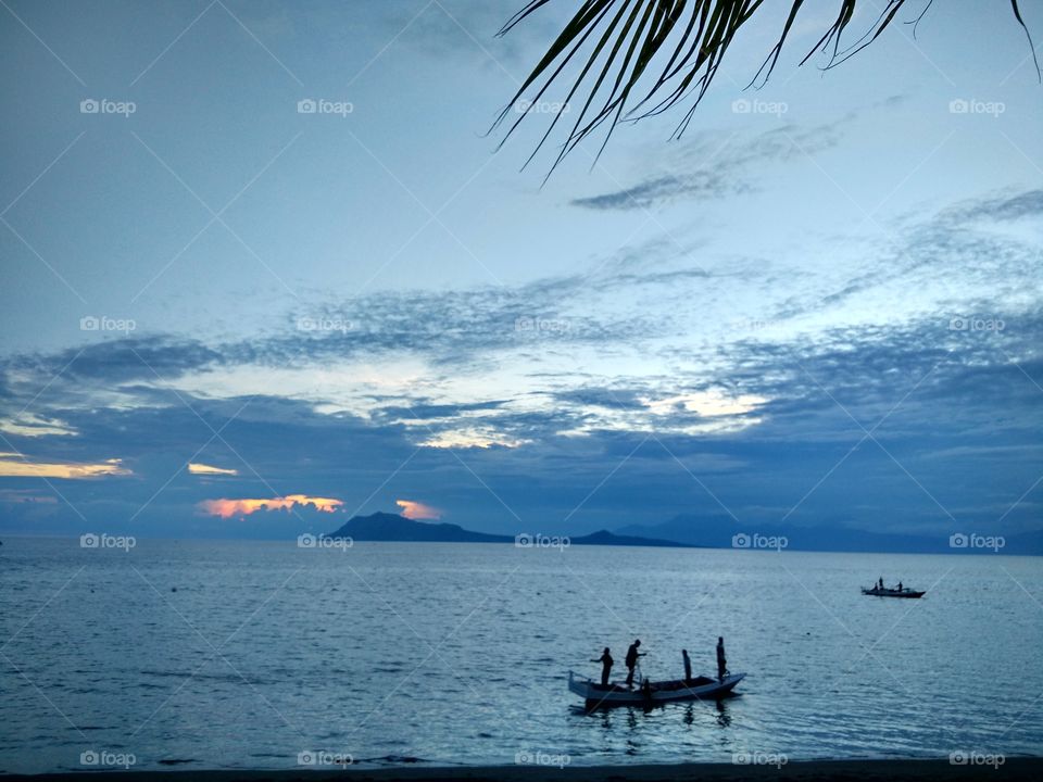 Silhouette of the fishermen on sunset