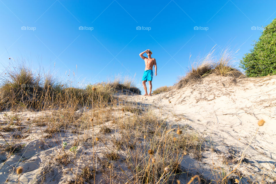 Young man standing on beach