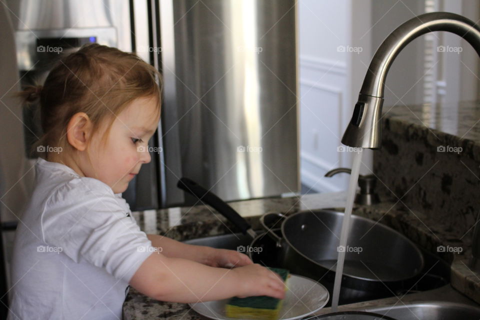 Girl washing dishes