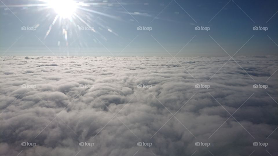 Above the clouds with sun rays from plane