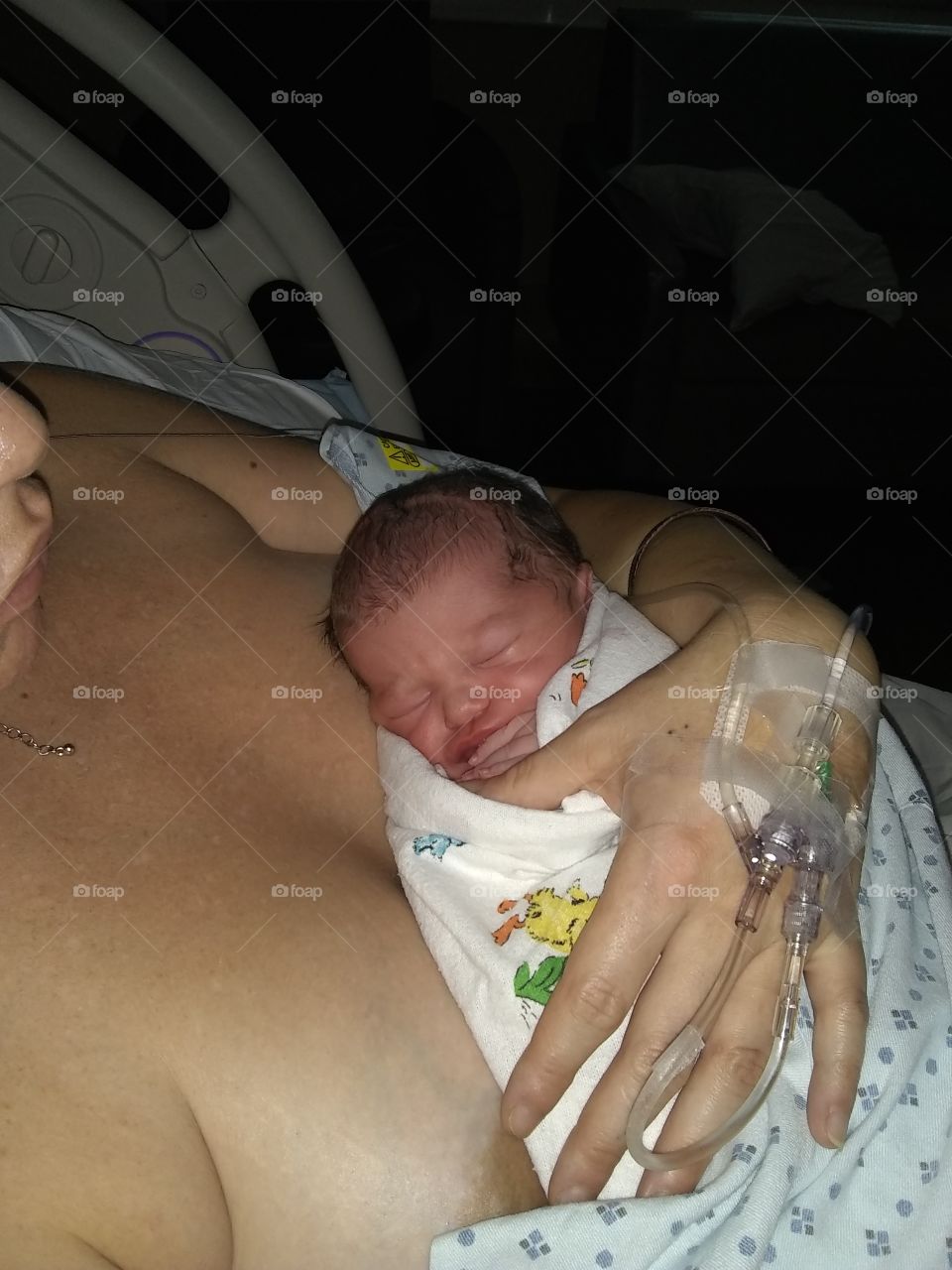 first time holding baby Damien