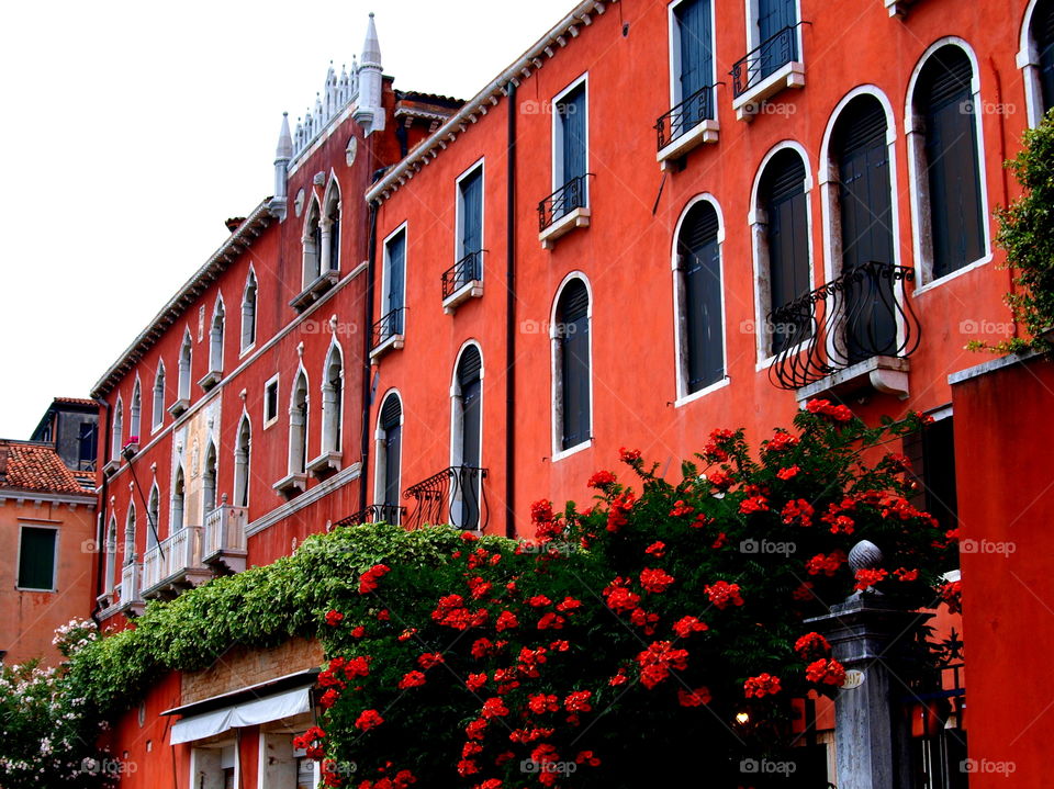 old red houses with red flowers in front