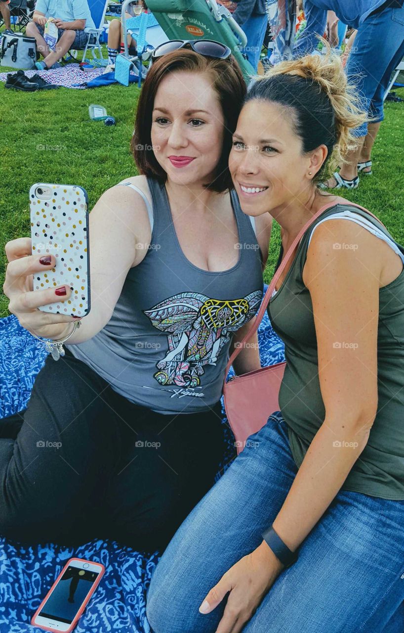 Two smiling woman taking selfie
