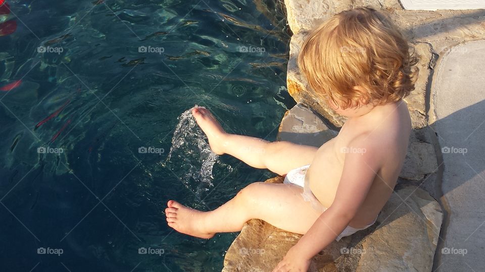 baby splashing water. summer fun