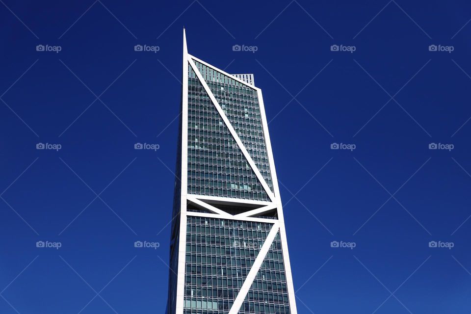 Glass skyscraper up in the blue sky